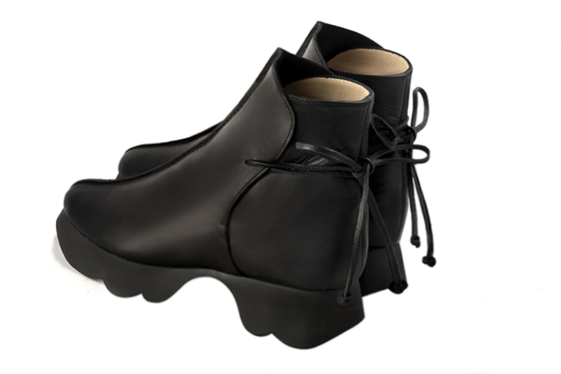 Satin black women's ankle boots with laces at the back. Round toe. Low rubber soles. Rear view - Florence KOOIJMAN